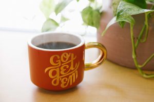 A coffee mug that says "Go Get Em"
