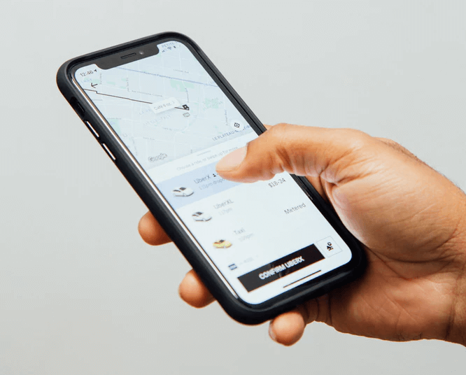 How much does Uber pay? Uber app on phone screen