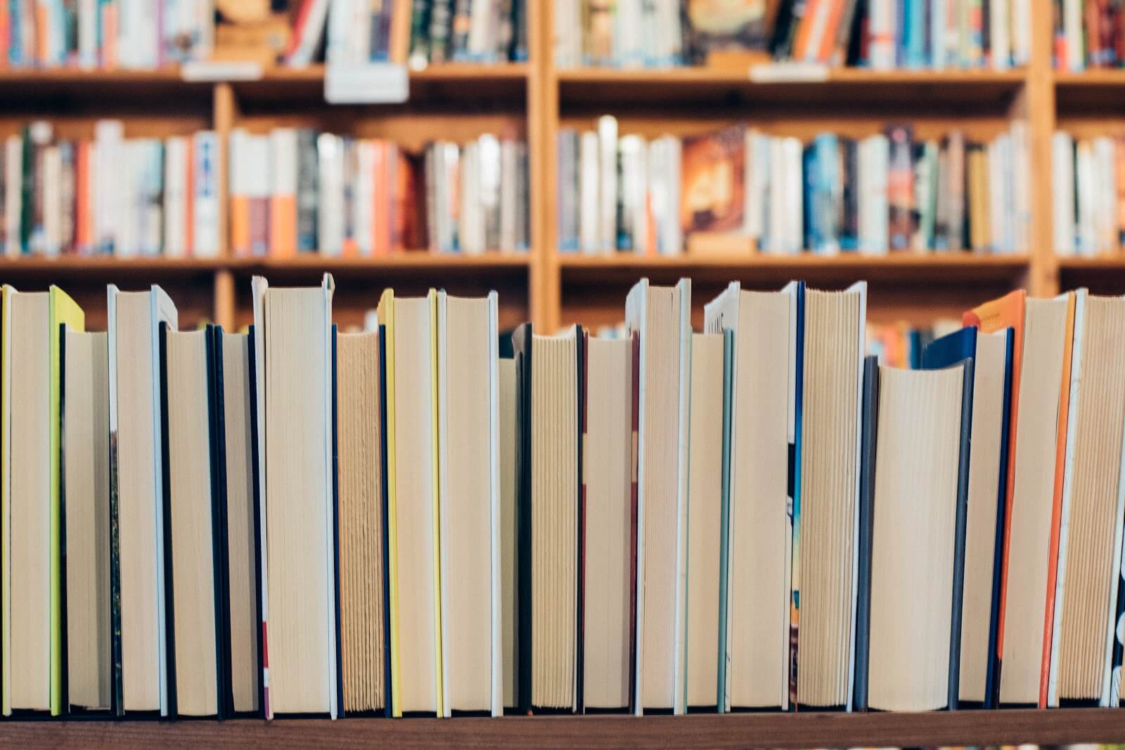 Books lined up on a library shelf