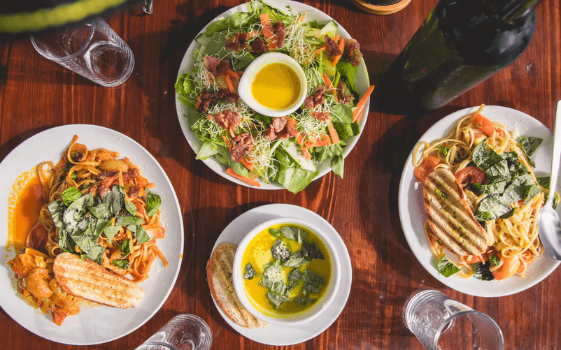 Aerial view of salads and pasta dishes on a table