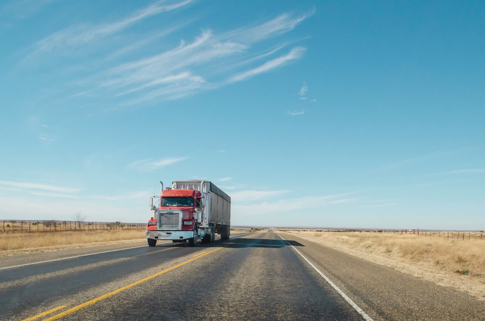 Semi truck driving on the wide open road