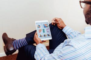 Opinion Outpost: A well-dressed man looks at charts on a tablet