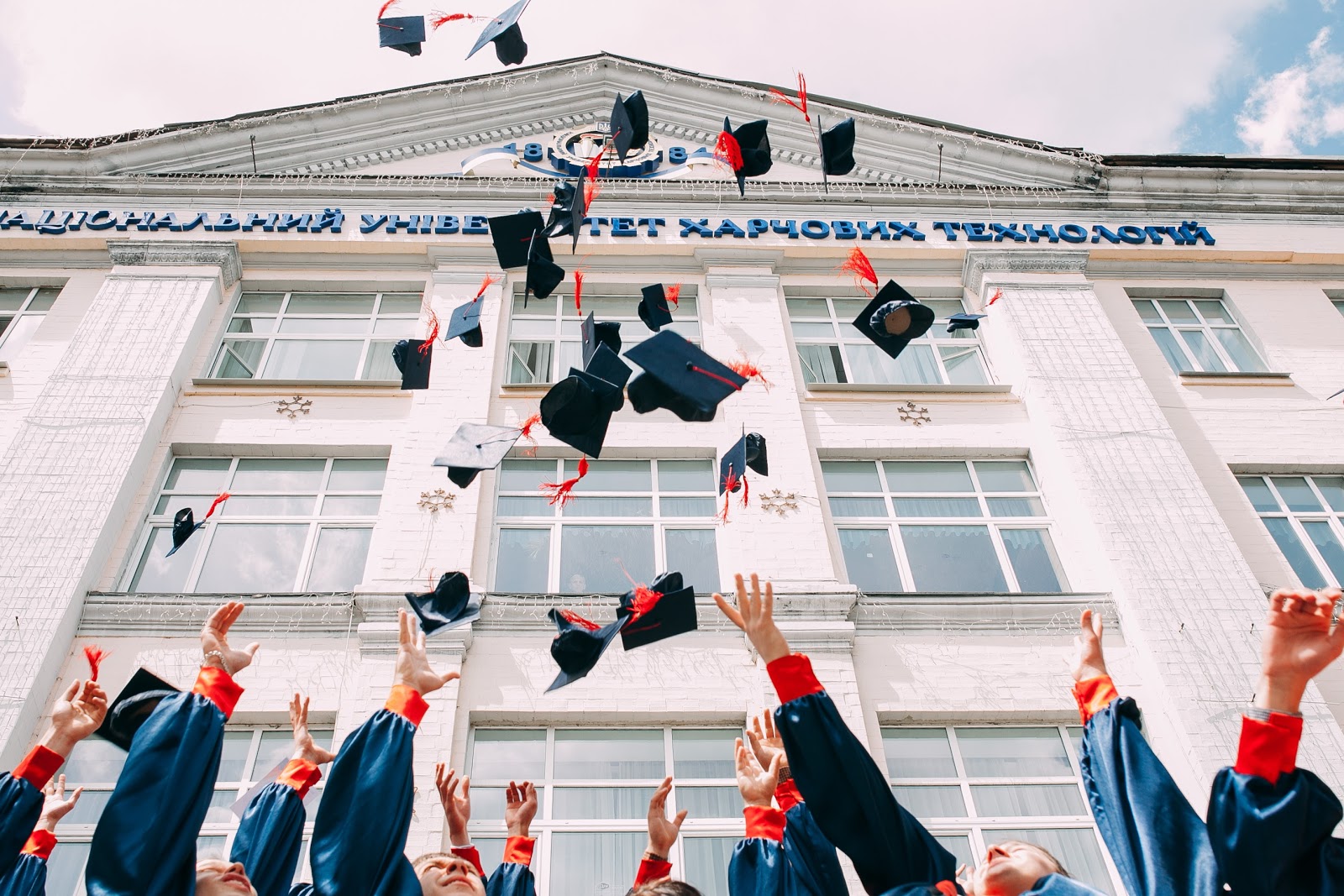 graduation class tossing graduation caps in the air