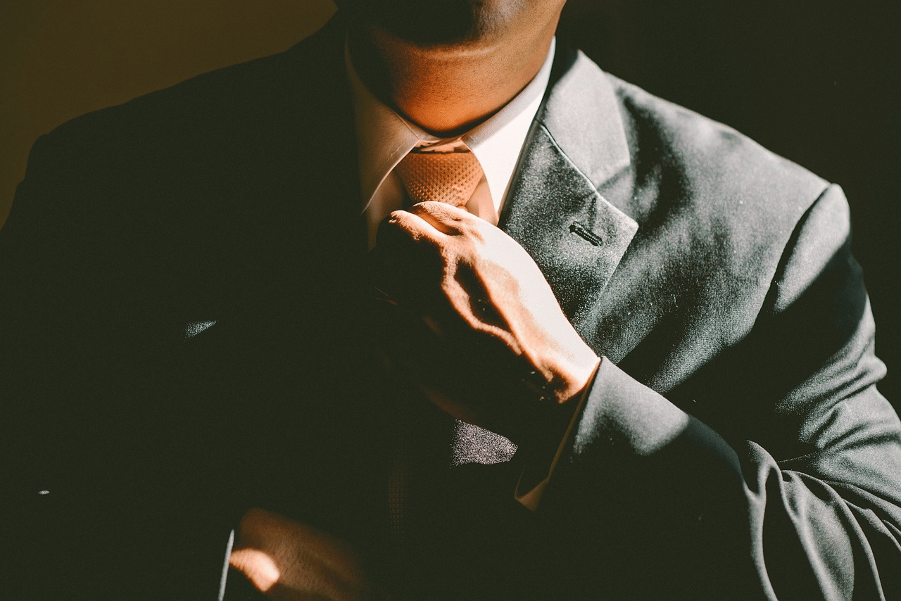 How to Build Self-Confidence: man adjusting tie