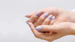 stock image showing nails on hands, cupped against one another - header graphic for a names for nail business post on gigworker.com